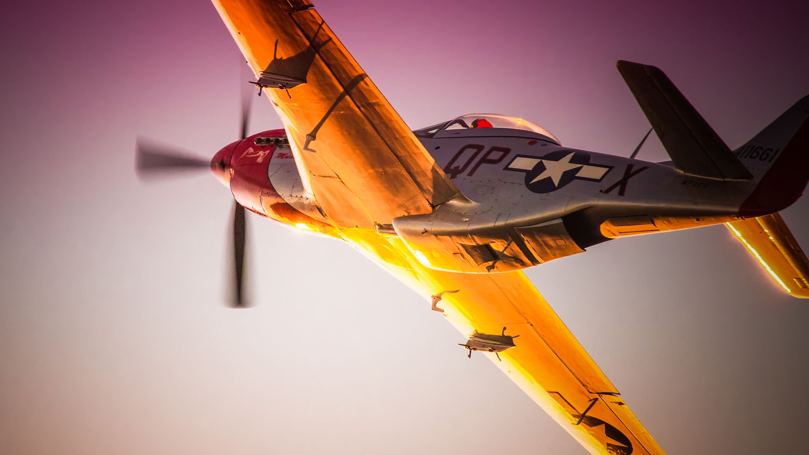 Sunset reflecting off the wing of a World-War-Two-era P-51D Mustang.